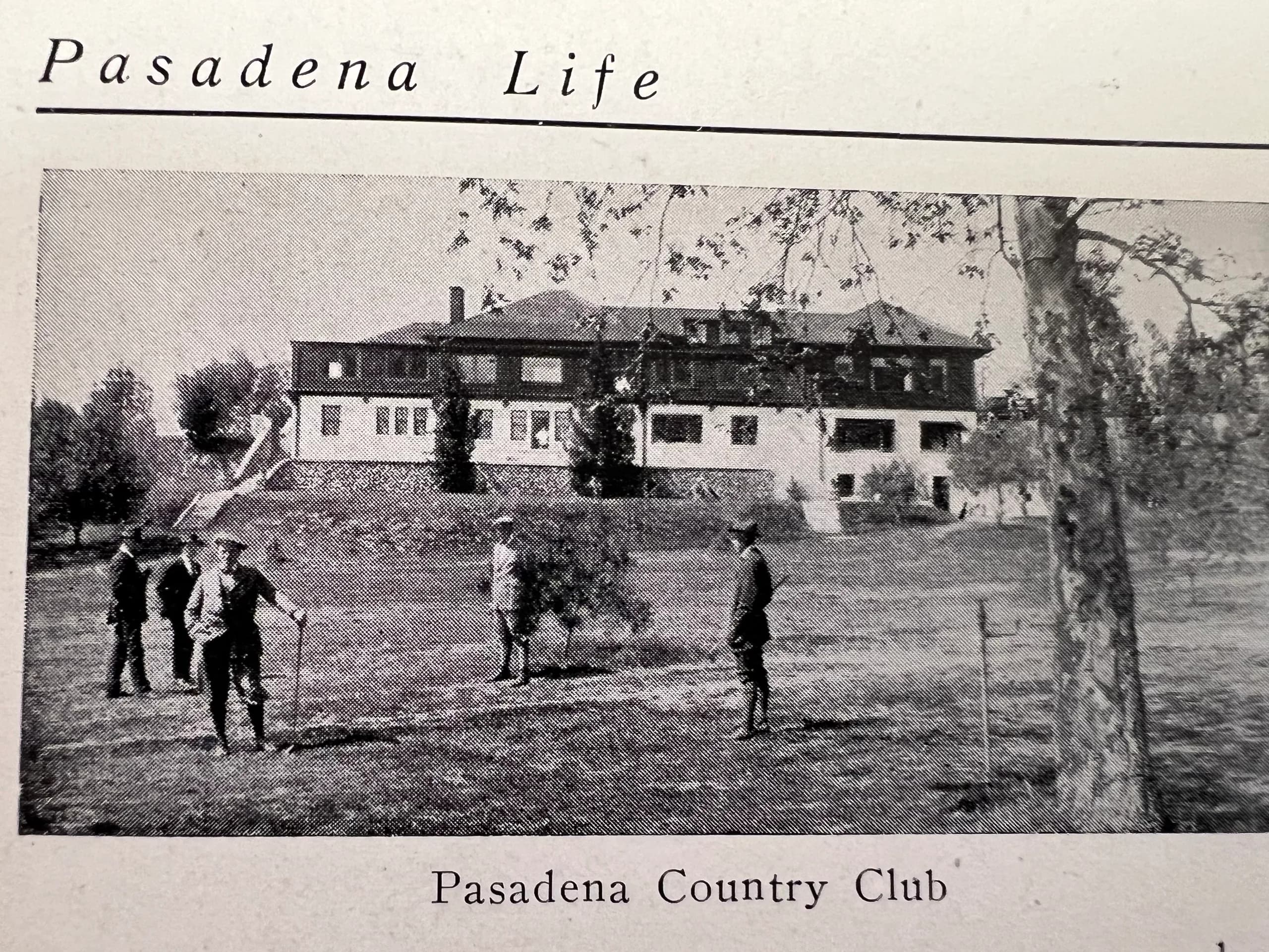 Clubhouse in background, men teeing off - looking West at the NW corner of the property